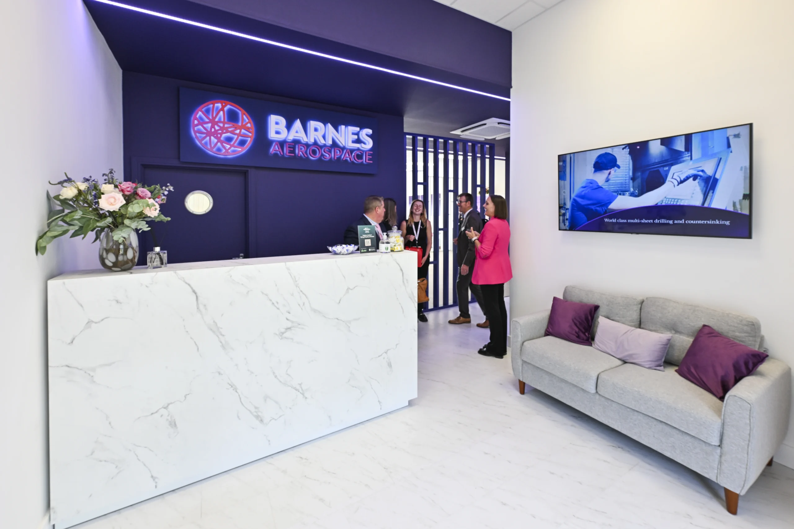 Barnes Aerospace exhibition stand hospitality area with seating and customer meeting space at Farnborough International Airshow 2026
